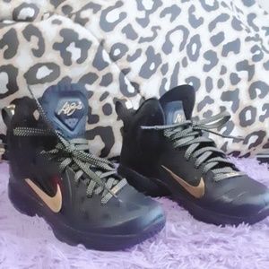 Black and gold Nike shoes